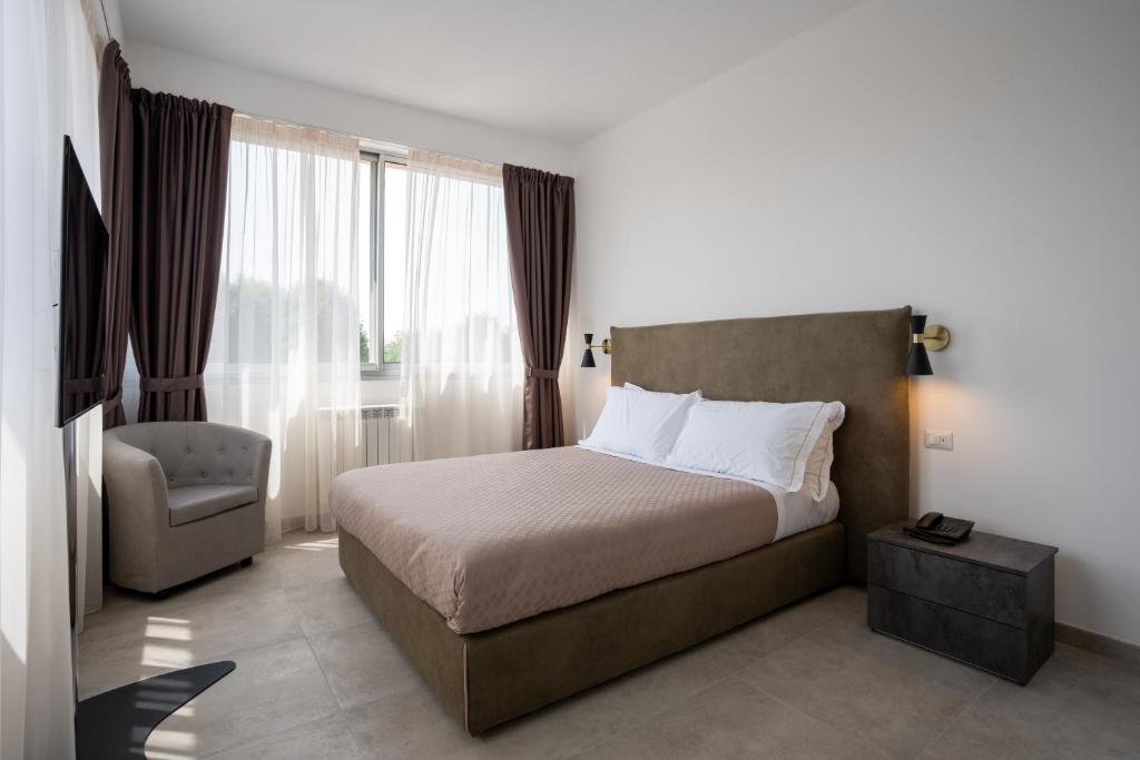 Postel nebo postele na pokoji v ubytování Hotel Bulà