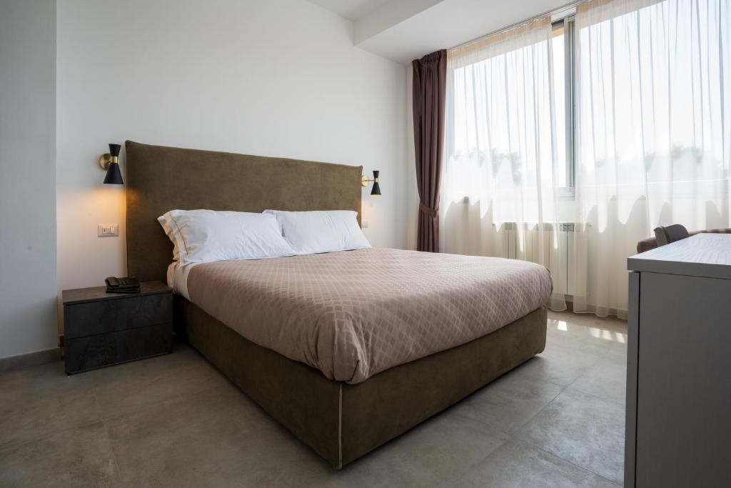 Postel nebo postele na pokoji v ubytování Hotel Bulà