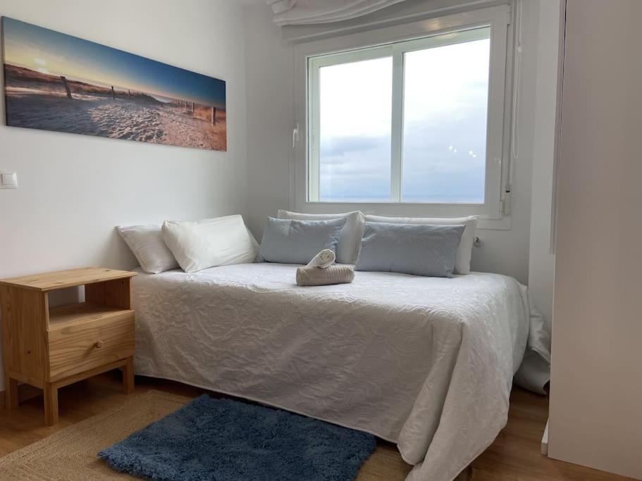 Giường trong phòng chung tại Sopela Sea Apartment
