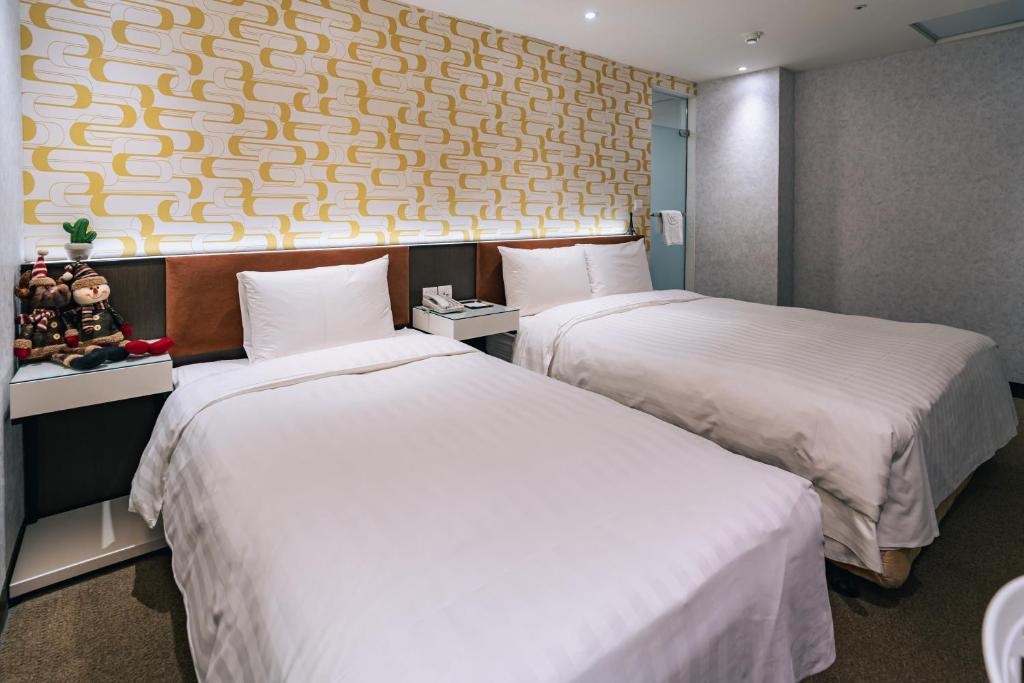 Ένα ή περισσότερα κρεβάτια σε δωμάτιο στο Hotel Puri Taipei Station Branch