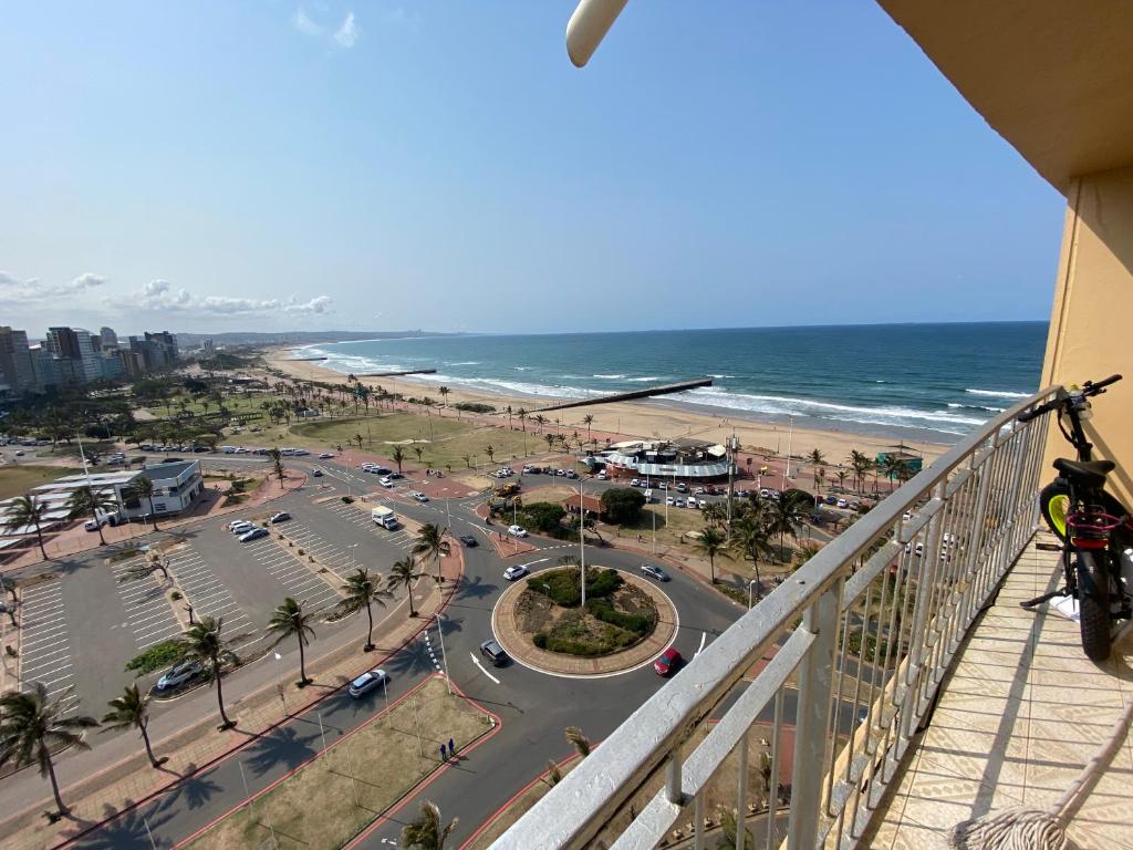 a balcony with a view of the beach and the ocean at Chasing The Sun in Durban