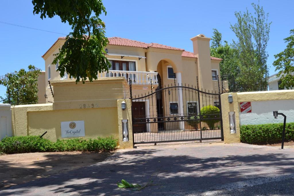 una casa con una puerta delante de ella en The Capital Guest House, en Gaborone