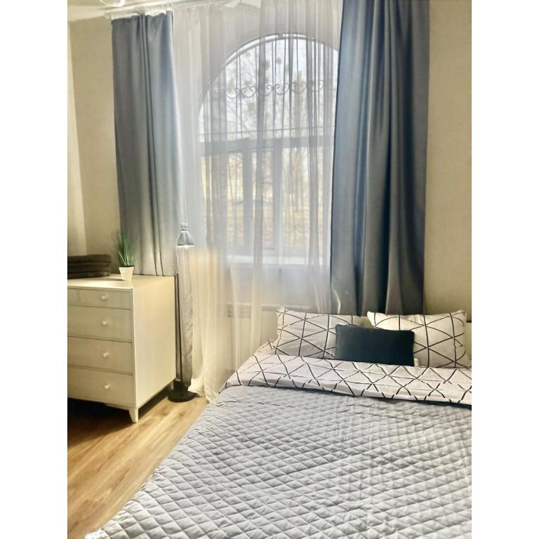 ein Schlafzimmer mit einem weißen Bett und einem Fenster in der Unterkunft Smart in Kharkov
