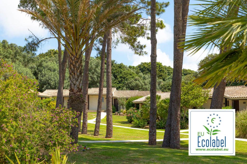 a sign in front of a resort with palm trees at Prea Gianca in Bonifacio