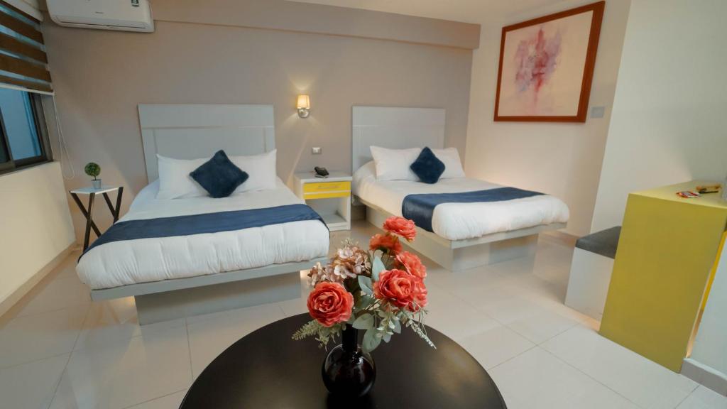 Postel nebo postele na pokoji v ubytování Hotel Quirasco