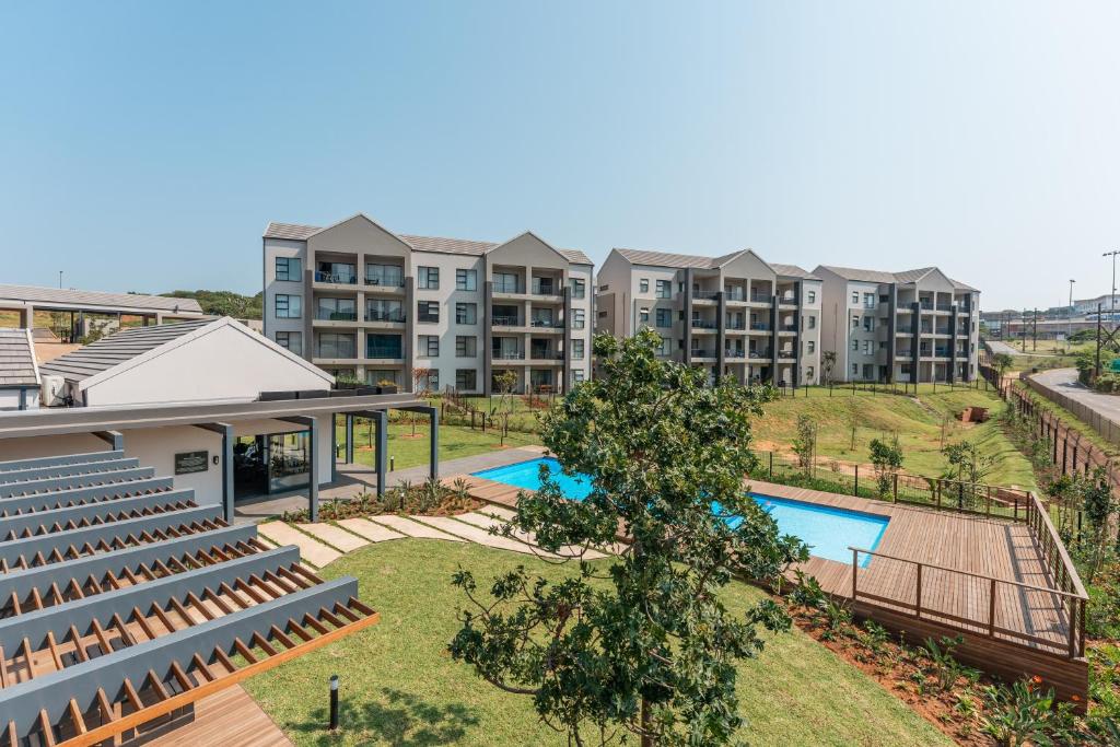 an aerial view of an apartment complex with a swimming pool at Ballito Village Luxury Apartments by DropInn in Ballito