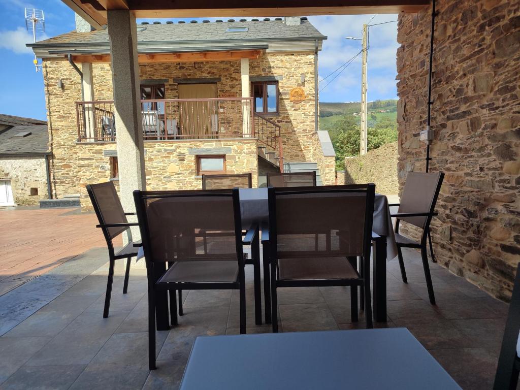 a black dining table and chairs on a patio at Apartamentos Rurales Torre de la Alcandra - 3 llaves - Asturias in Vegadeo