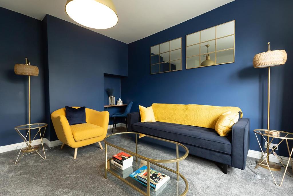 a blue living room with a couch and a chair at HIGHBANK HOUSE - Three Bed Stylish House in North Yorkshire in Harrogate