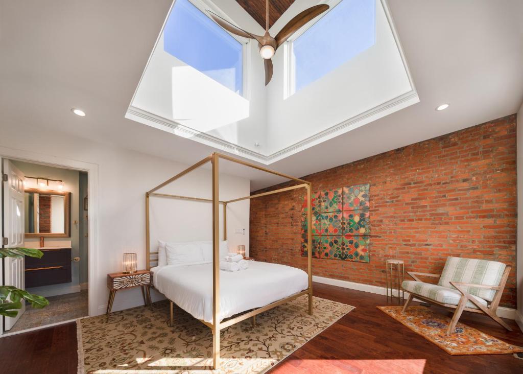 a bedroom with a bed and a large window at Your Perch at University City in Philadelphia
