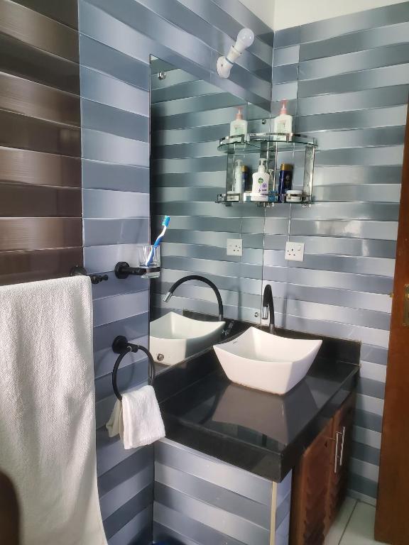 a bathroom with a sink and a mirror at Muna Beachfront Apartment in Malindi