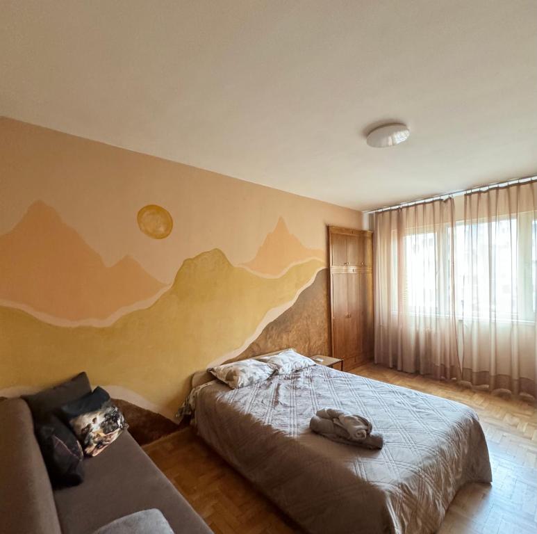 a bedroom with a bed and a couch at Spacious Apartment next to South Park Просторен Апартамент до Южен Парк Top Location in Sofia
