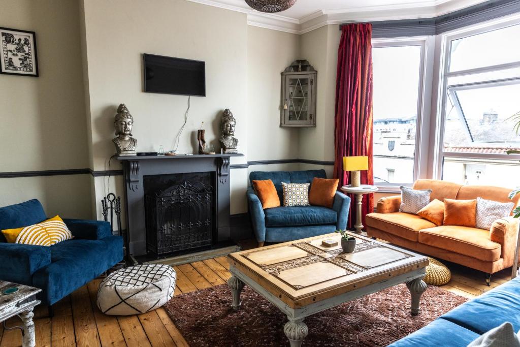 a living room with blue couches and a fireplace at CloudZen in Kent
