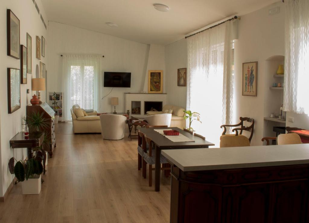 a living room with a couch and a table at Villa Degli Ulivi in Cassina deʼ Pecchi