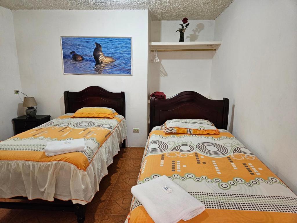 Postel nebo postele na pokoji v ubytování Hostal Cerro Azul