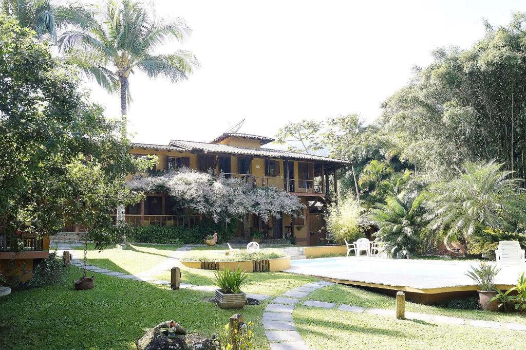 a large house with a garden and a building at Pousada Florence in Ilhabela