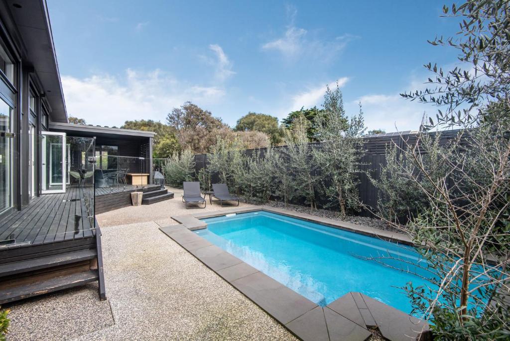 a swimming pool in the backyard of a house at The Pavilion with pool St Andrews Beach in Saint Andrews Beach