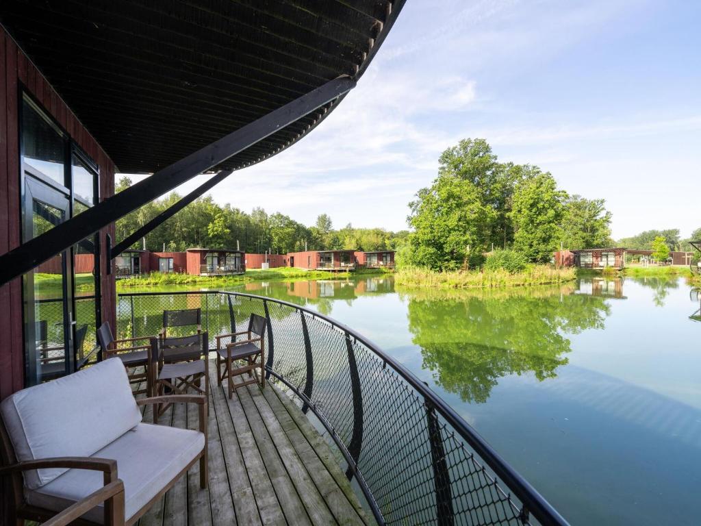 a balcony with chairs and a view of a river at Charming Antoing Retreat in Antoing
