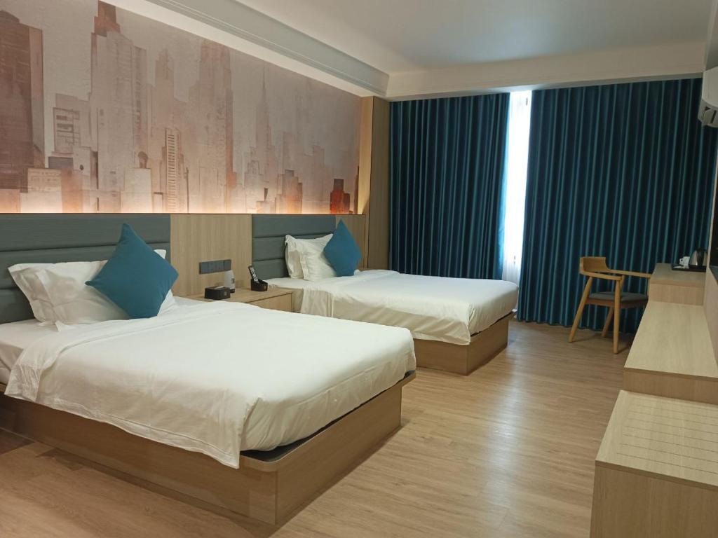 Postel nebo postele na pokoji v ubytování Fan's Hotel Palo