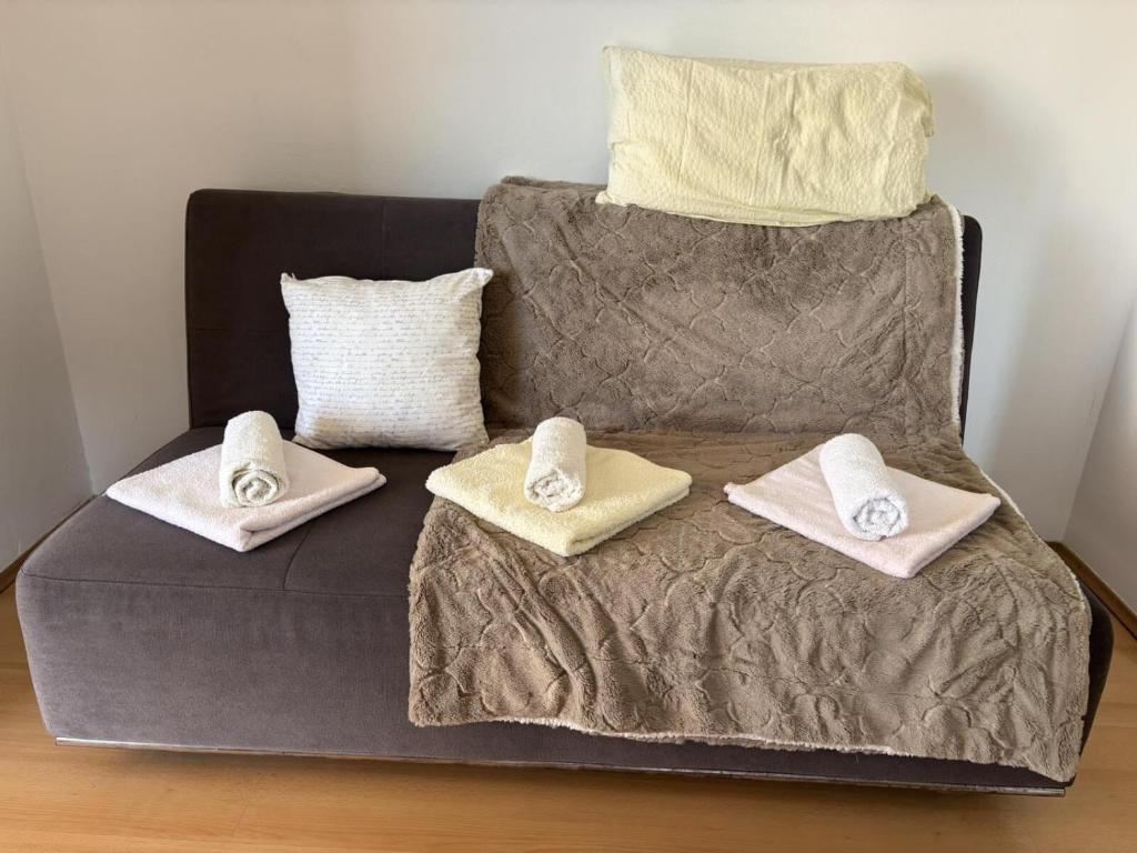 a couch with two pillows on top of it at Apartments Strahija in Barbat na Rabu