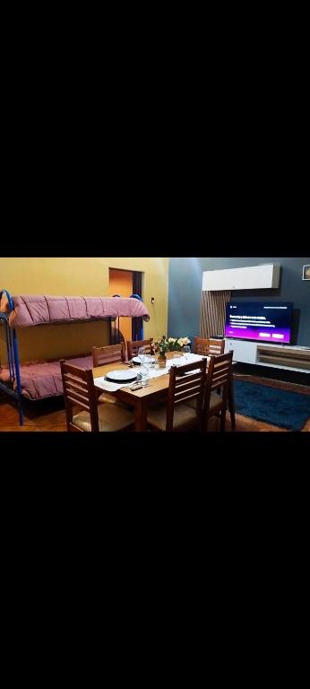a dining room with a table and a couch at Departamento Santa Teresita in Villa Unión
