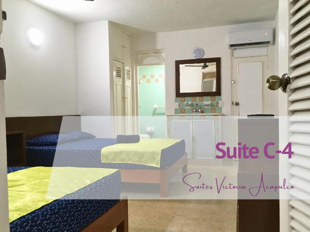 Ένα ή περισσότερα κρεβάτια σε δωμάτιο στο Suite Victoria Acapulco 3