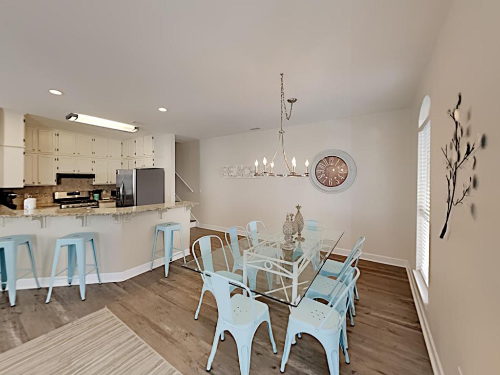 a dining room and kitchen with a table and chairs at Changes In Latitude in Destin
