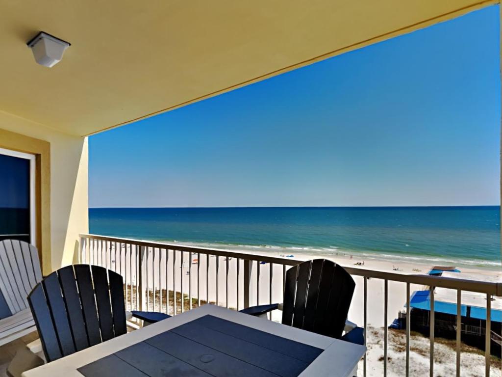 a view of the beach from a balcony with a table and chairs at Boardwalk #787 in Gulf Shores