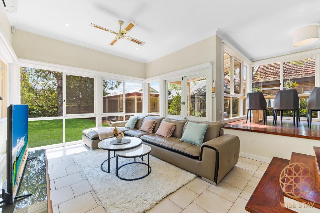 a living room with a couch and a table at Greenwich Luxury near WharfTrainCBD steps to Sea in Sydney