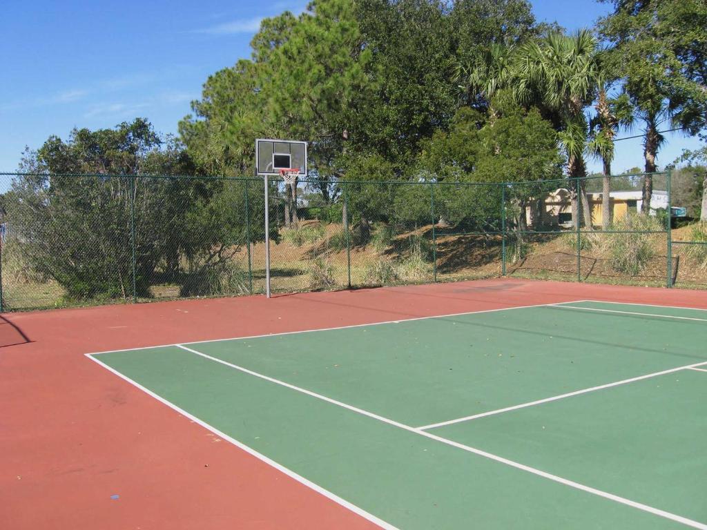 a tennis court with a basketball hoop on it at Changes In Latitude in Destin