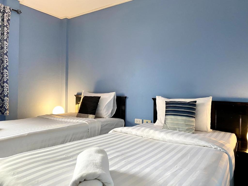 Postel nebo postele na pokoji v ubytování Minotel Patong