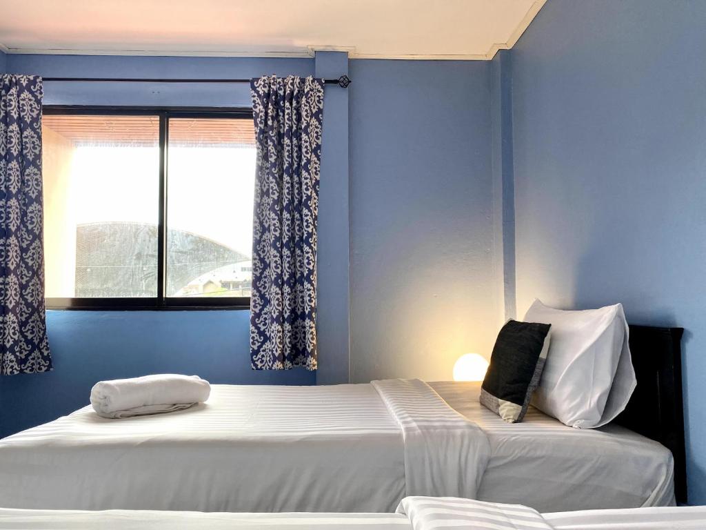 Postel nebo postele na pokoji v ubytování Minotel Patong