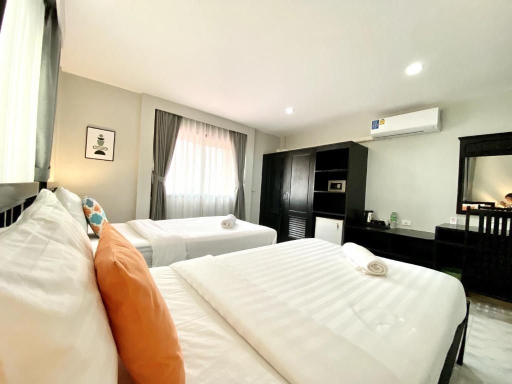 Postel nebo postele na pokoji v ubytování Minotel Patong