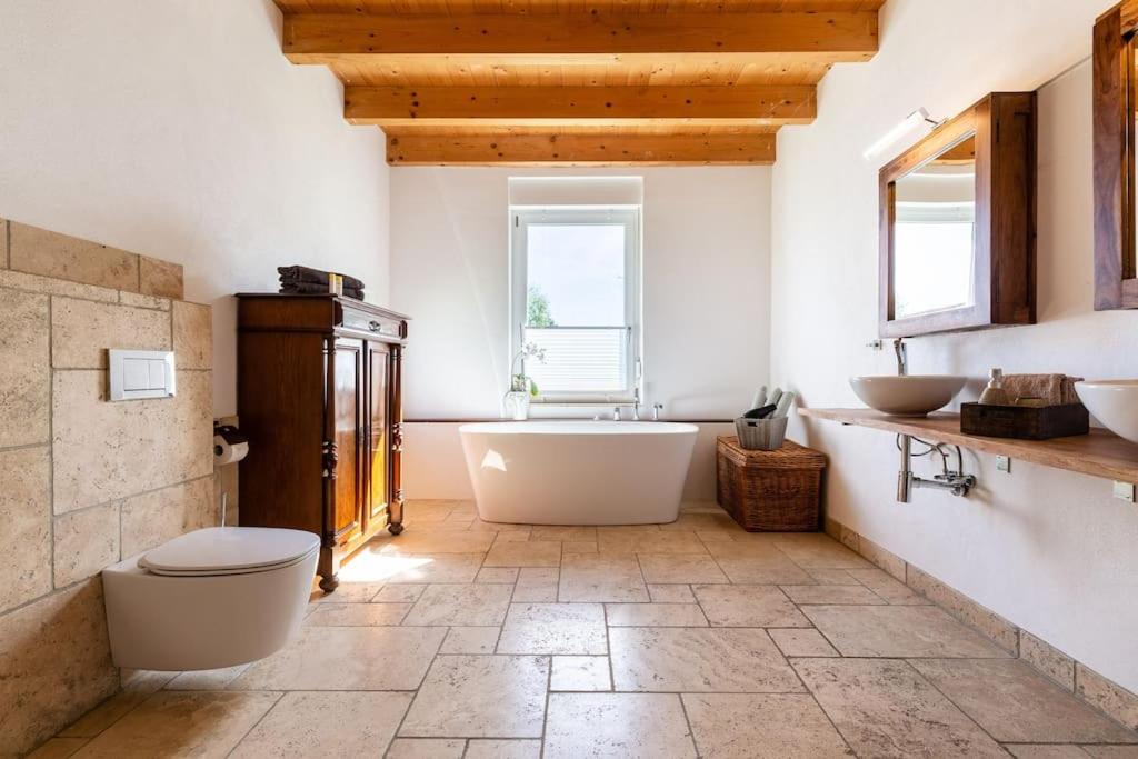 a bathroom with a large tub and two sinks at Privat Apartment- Near Strasbourg, Baden Baden in Rheinau