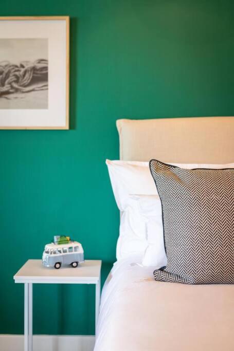 a bed with a toy car on a side table at Studio 7 - Hermanus Waterfront Apartments in Hermanus