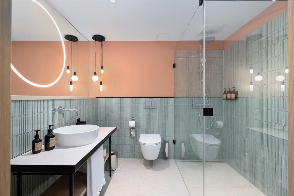 a bathroom with a sink and a toilet and a shower at The Yarn in Horgen