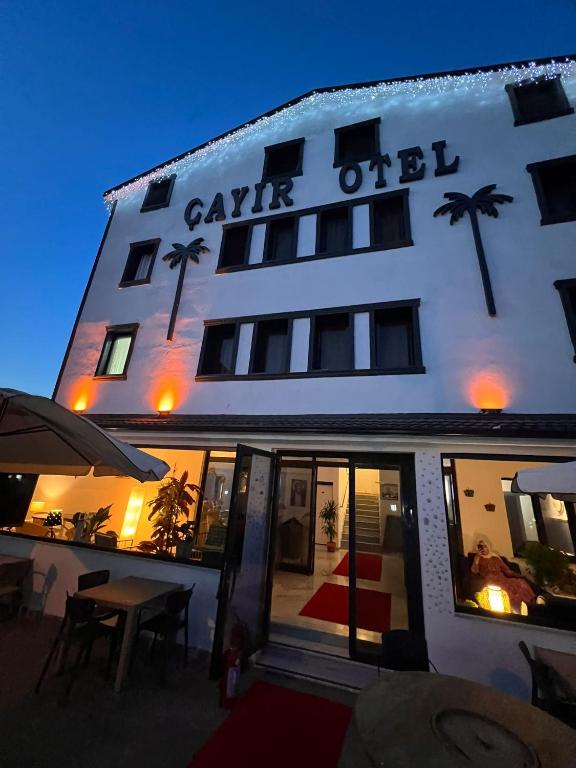 a large white building with palm trees on it at çayır butik otel in Marmaraereglisi