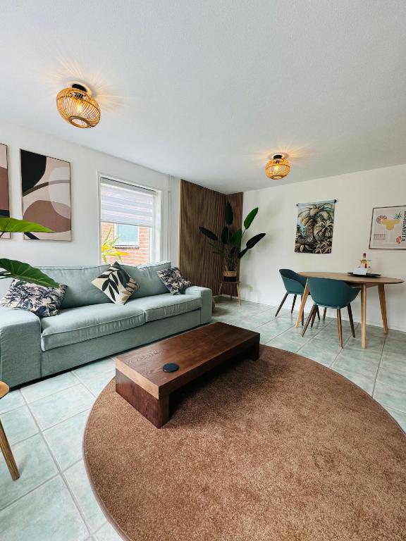 a living room with a couch and a coffee table at Beachhouse De Dahlia in Noordwijk aan Zee