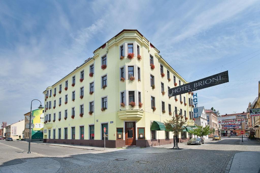 a white building with a street sign in front of it at Brioni Boutique Hotel 4* in Ostrava