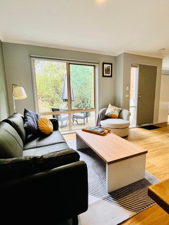 a living room with a couch and a coffee table at Marengo Beach Studios- Pet Friendly in Marengo