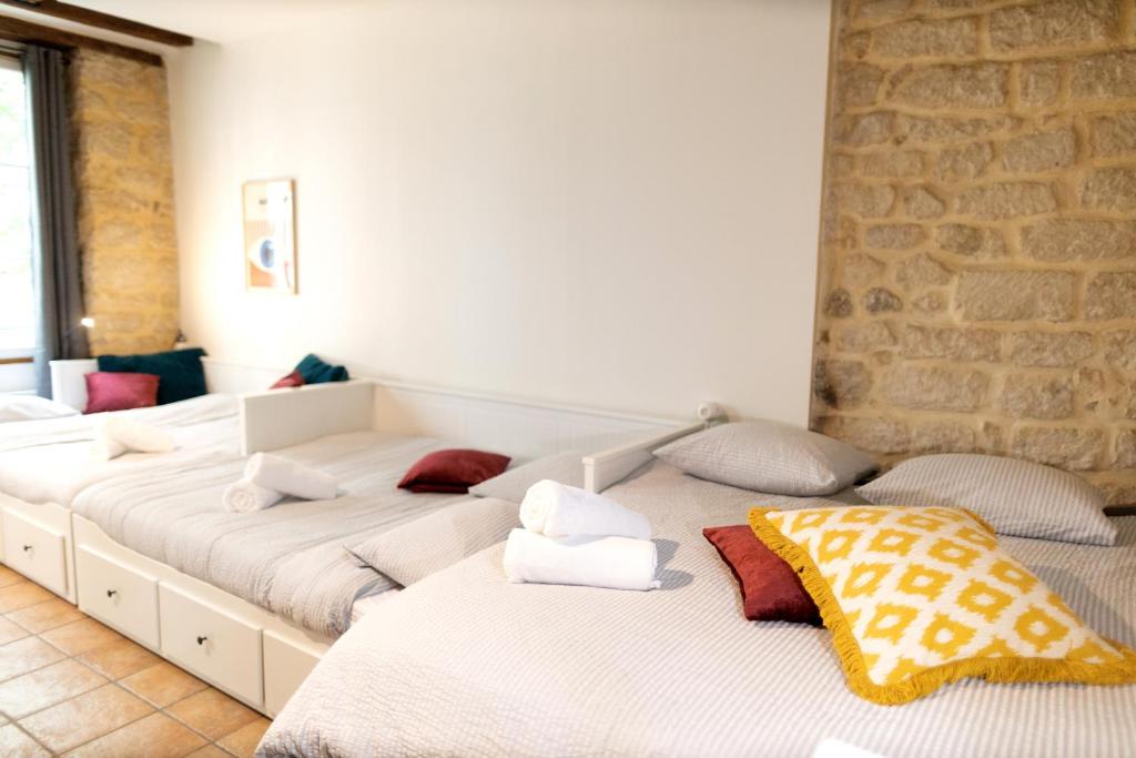 deux lits dans une chambre avec un mur de briques dans l'établissement Atelier des Shadoks, à Paris