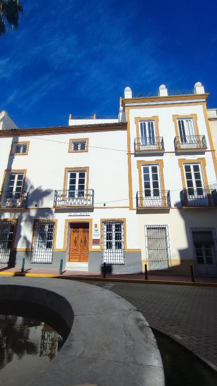 a large white building with doors and windows at El Palacete de Cuevas in Cuevas del Almanzora