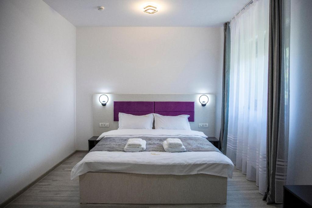 Postel nebo postele na pokoji v ubytování Casa Orhideea