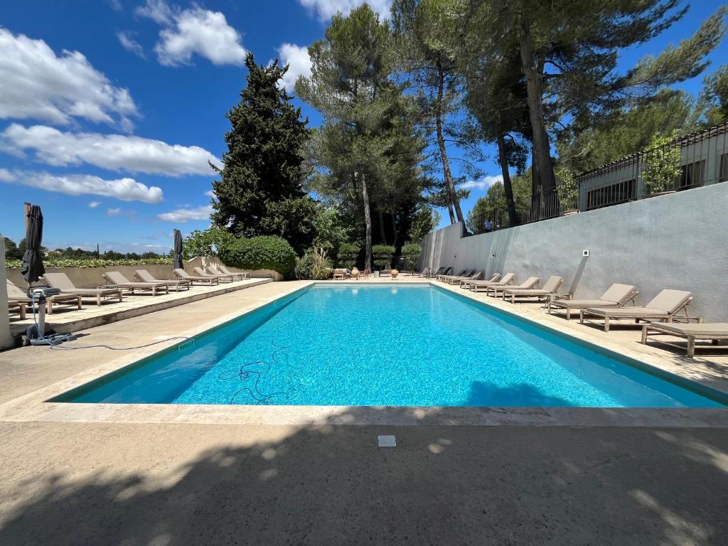 a swimming pool with chaise lounge chairs around it at Domaine Gao in Aix-en-Provence