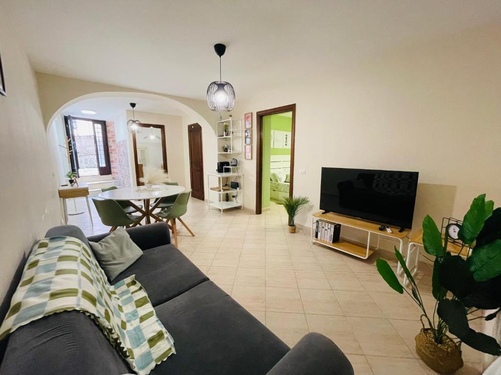 a living room with a couch and a tv at Castrum Home - Castelli Apartments in Castel Gandolfo