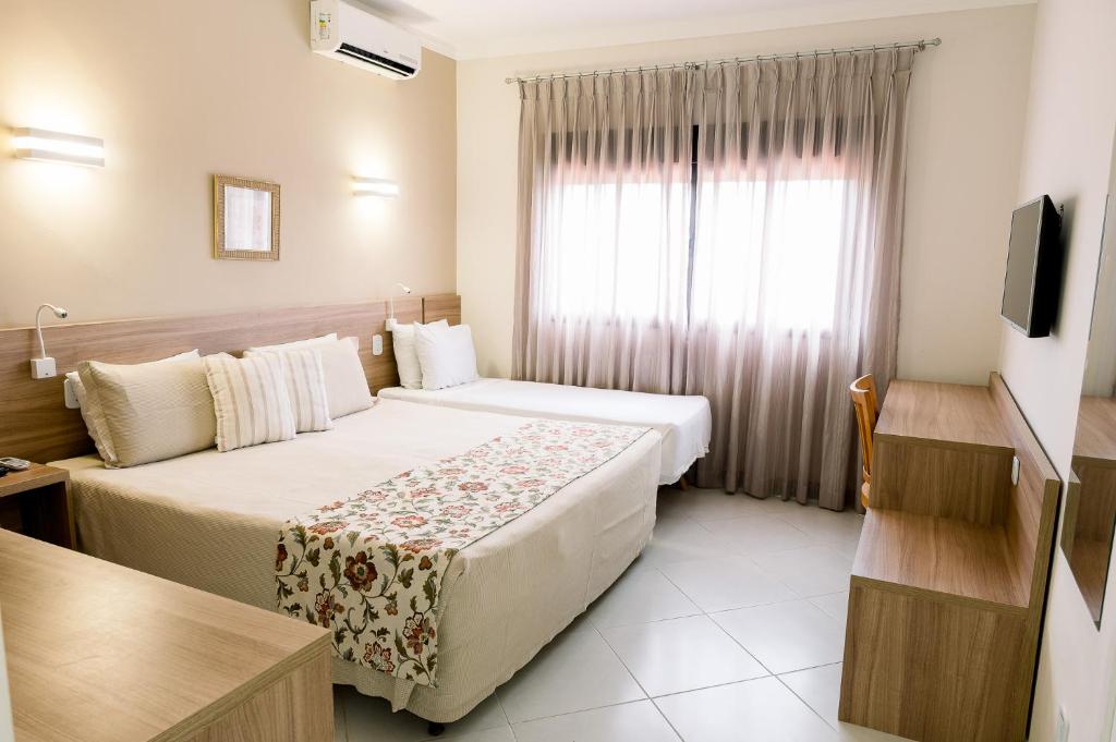 Cama ou camas em um quarto em Guararema Parque Hotel