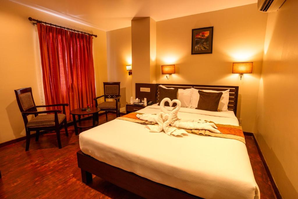 Postel nebo postele na pokoji v ubytování The Luxe Inn Boutique Hotel