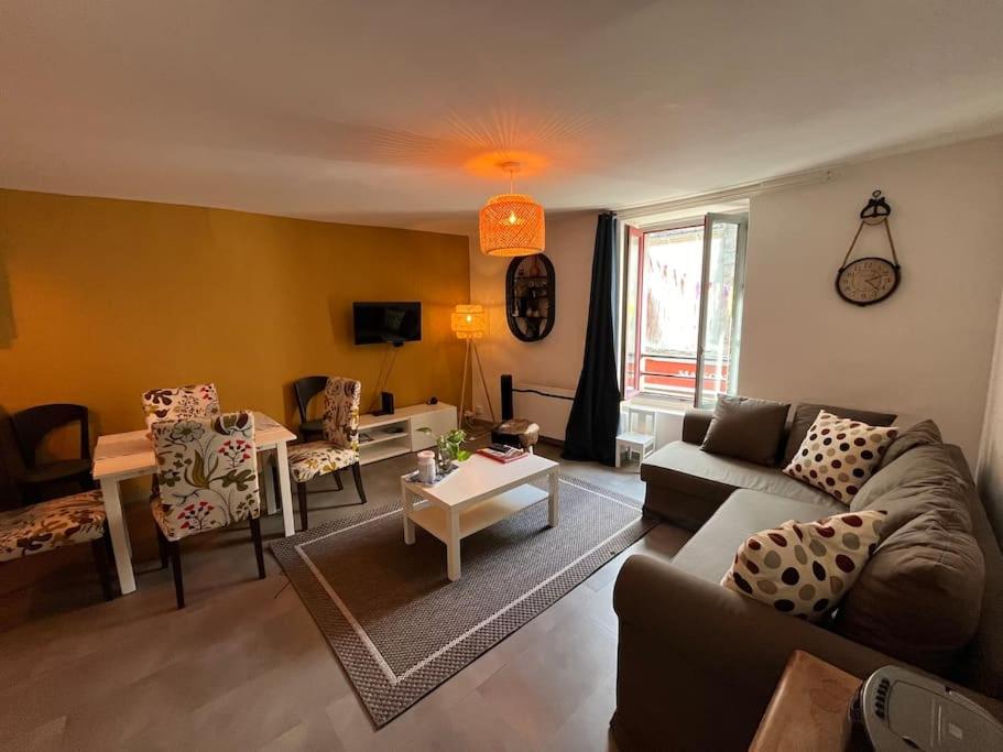 a living room with a couch and a table at Appartement Remparts de Guérande in Guérande