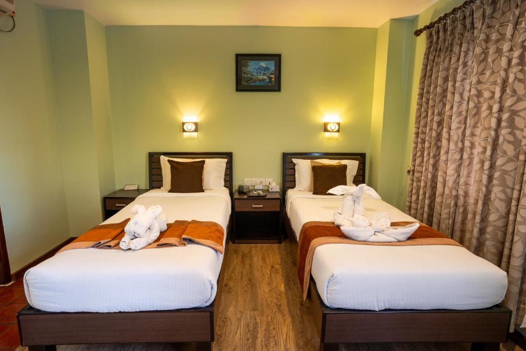 Postel nebo postele na pokoji v ubytování The Luxe Inn Boutique Hotel
