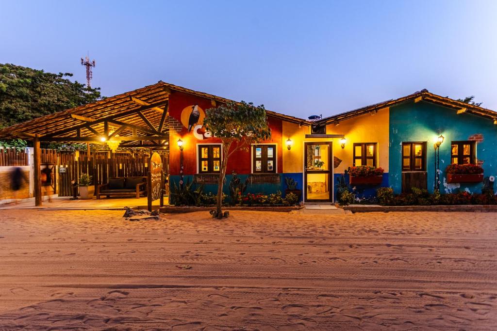 a colorful house in the middle of a street at Pousada Carcará in Jericoacoara