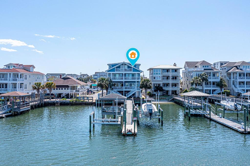 a marina with a dock and some buildings on the water at The Blue Pearl by Sea Scape Properties in Wrightsville Beach